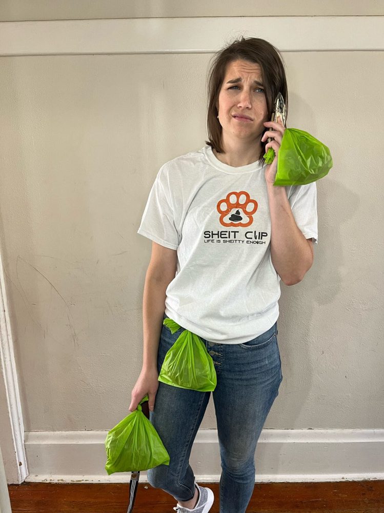 Dog owner juggling poop bags and a phone call